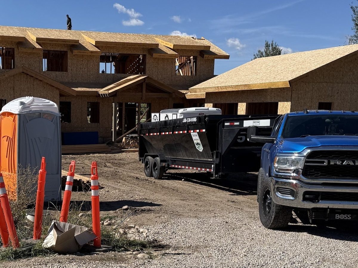 Western Ops roll-off dumpster and trailer on a new home build in East Idaho